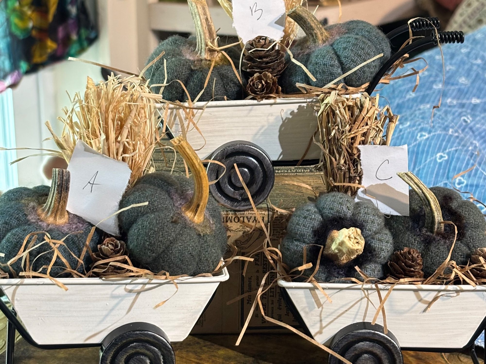 White Metal Wheelbarrow with Overdyed Blue Small Pumpkins and Acorns